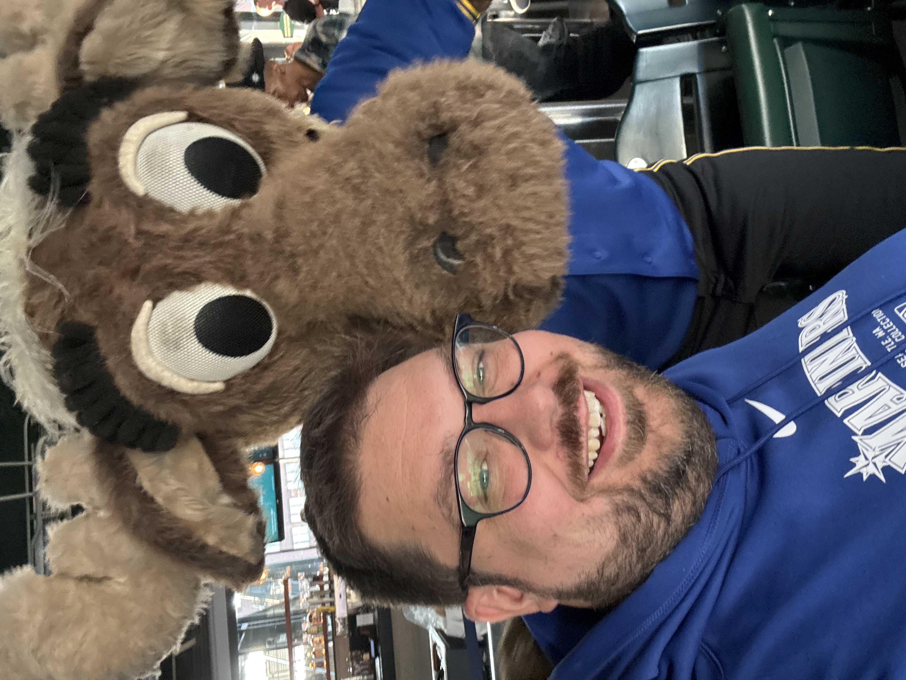 Matt grinning next to the Mariner Moose at the ballpark.